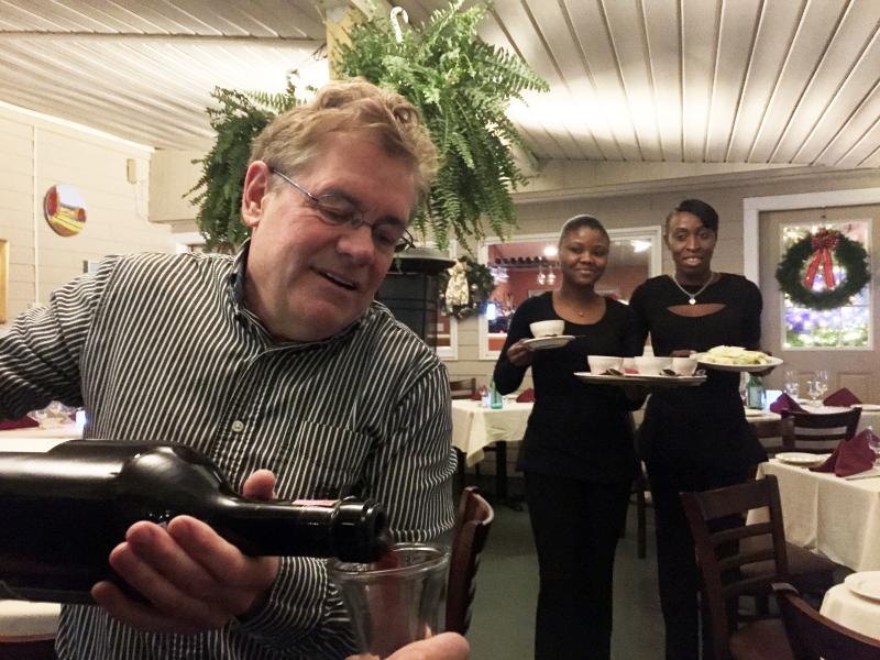 Ports of Italy manager Jeff Teel pours wine from a three-liter magnum on Friday, Dec. 2. SUZI THAYER/Boothbay Register