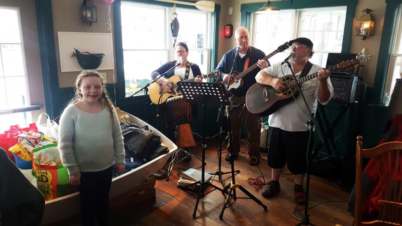 Suzie Edwards in front of the love-filled boat, and the Dave Gagne Band, at McSeagull’s on Feb. 19. Courtesy of Steve Edwards