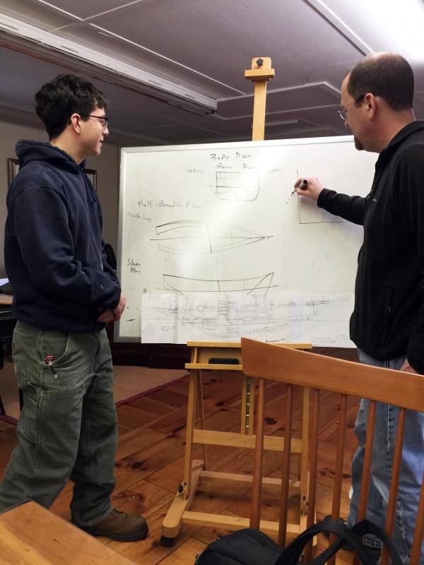 Nick Labonte, left, a senior at BRHS, gets instruction on some of the finer points of hull design from Dr. Douglas Read, Associate Professor of Engineering at Maine Maritime Academy. Courtesy of Eric Graves/Boothbay Harbor Shipyard