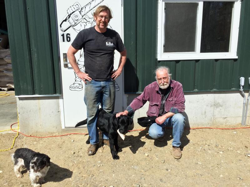 Erik and Al Carlson at the plant in Boothbay with Erik’s dog, Sula, and Elliot in the foreground. SUZI THAYER/Boothbay Register
