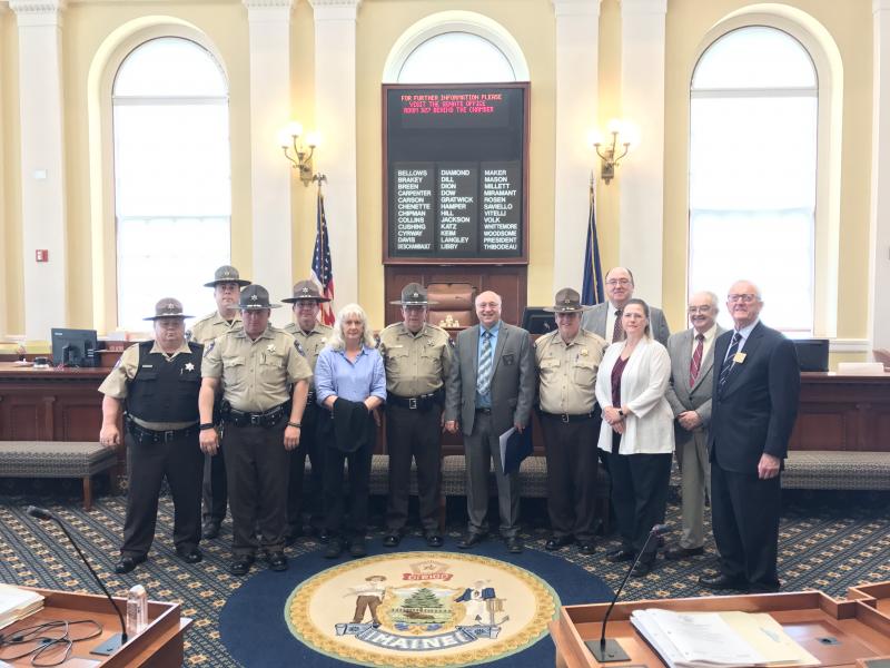 Present for the presentation are, from left, Deputy Michael Gustafson, Chief Deputy Rand Maker, Deputy James Read, Sergeant Aaron Mortensen, Beth Jordan, Deputy Clayton Jordan, Sen. Dana Dow, Sheriff Todd Brackett, Lieutenant Michael Murphy, County Administrator Carrie Kipfer, Commissioner William Blodgett and Commissioner Hamilton Meserve. Courtesy photo