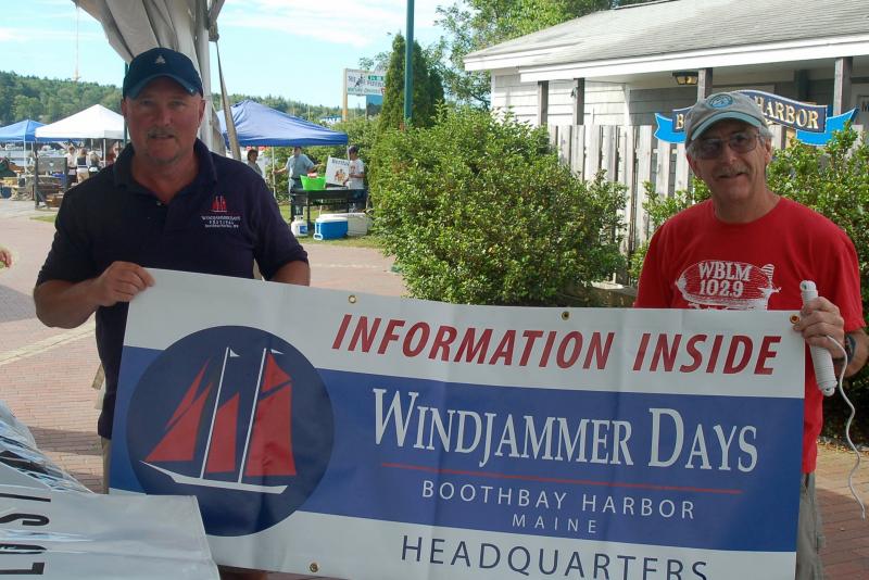 Mark Gimbel and Pete Ripley prepare to hoist the Windjammer Days banner. ART MAYERS/Boothbay Register