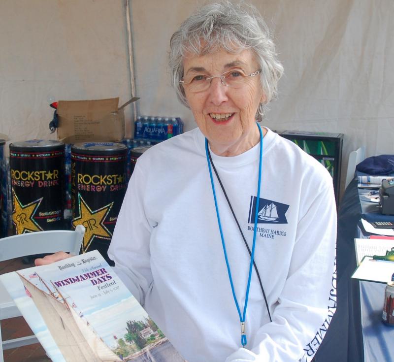 Volunteer Karen Baush holds up a Windjammer Days program. ART MAYERS/Boothbay Register