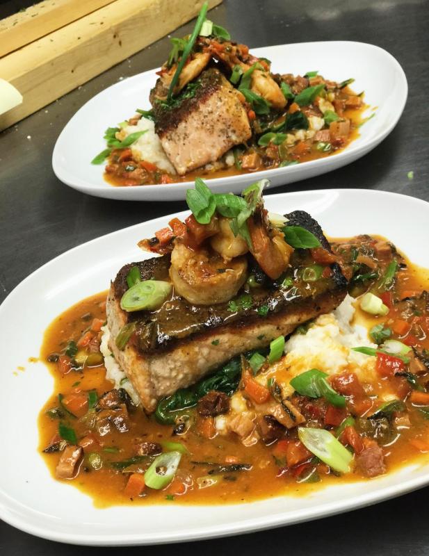 Seared salmon with shrimp and grits. Courtesy of Kelly Patrick Farrin