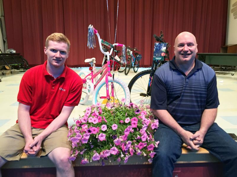 Alex, left, and Stuart Smith, coordinated the Bikes for Books event and presented the bikes at Edgecomb Eddy School on June 7. SUZI THAYER/Boothbay Register