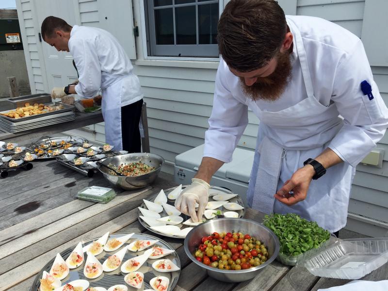 Executive Sous Chef Nathaniel Adam, left, and Sous Chef Eric Jones prepare hors d’oeuvres on the terrace of the inn. SUZI THAYER/Boothbay Register