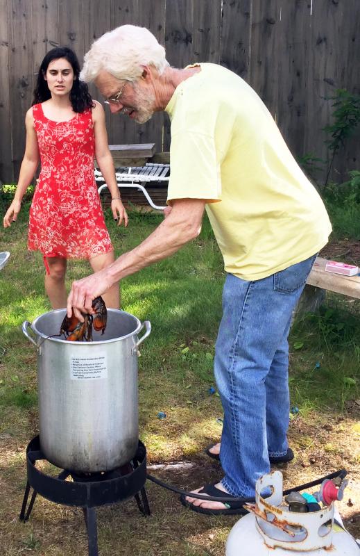 Pete murders the lobsters while Sophia watches, looking a little trepidatious. She is, after all, a vegetarian. SUZI THAYER/Boothbay Register