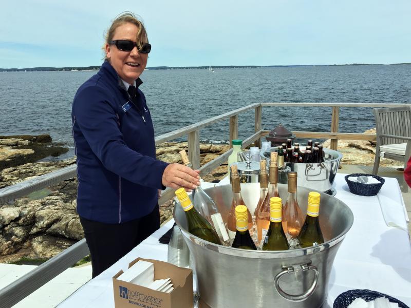 Kim Foye serves wine, cocktails and soft drinks on the terrace of the inn. SUZI THAYER/Boothbay Register
