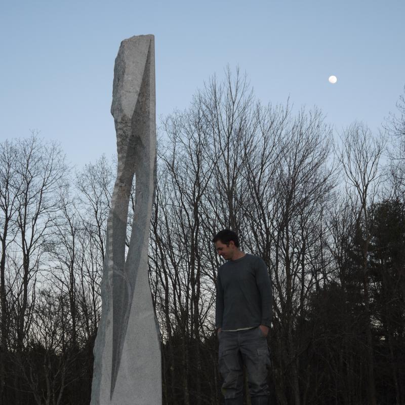 Artist Miles Chapin of Arrowsic with his piece Expanse, carved from granite and measuring 147 inches x 47 inches x 33 inches. Chapin grew up in Maine and received his B.A. in human ecology from College of the Atlantic in Bar Harbor. Chapin is one of the younger sculptors featured at MCSS but has already received critical acclaim for his unique works inspired by his local surroundings and interactions with nature. Courtesy photo
