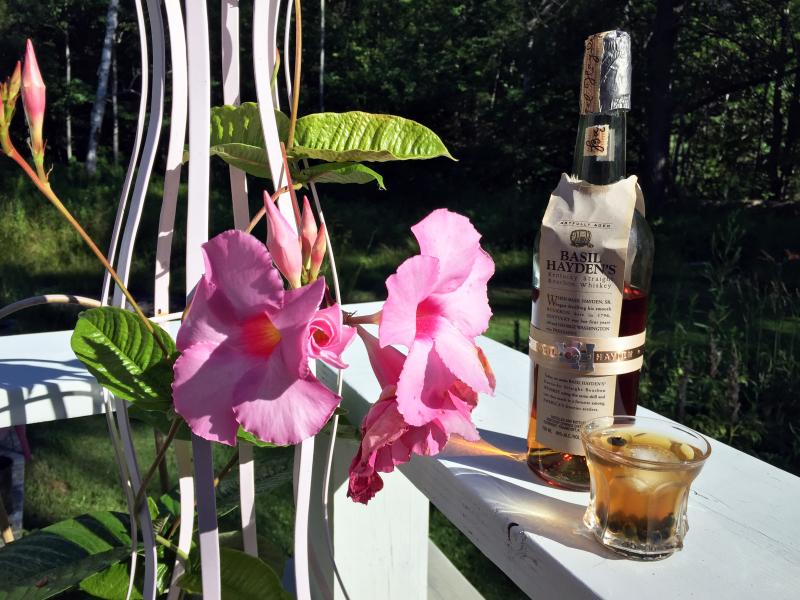 Cocktail hour on the deck: A cute little Heisey glass with Basil Heyden’s bourbon, a splash of blood orange bitters, and a few frozen blueberries. SUZI THAYER/Boothbay Register