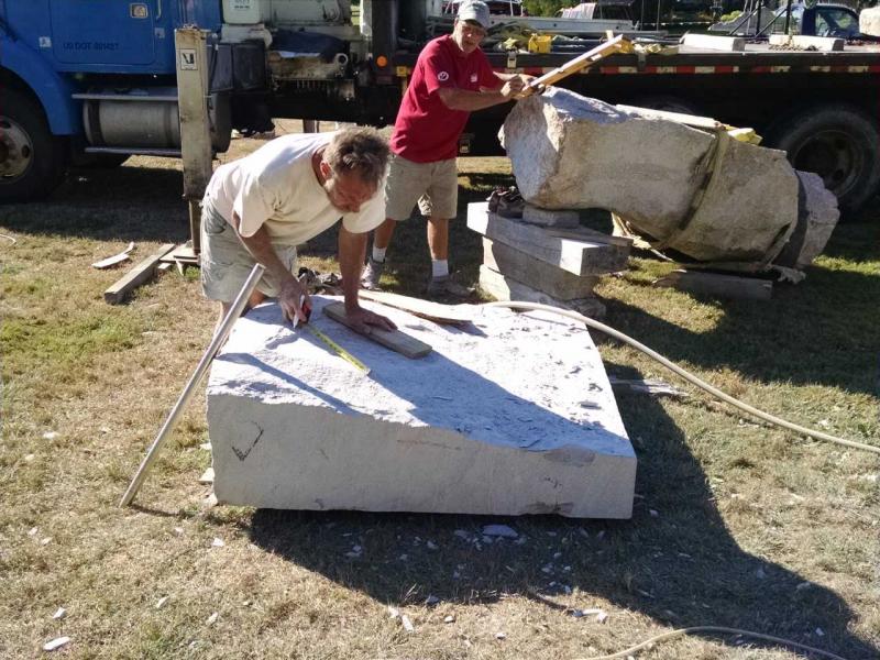 Dan Ucci of Pittston (in red) is working with a large piece of Jonesboro Red from J.C. Stone. His project has become very collaborative with others pitching in including Andreas von Huene ( in yellow.) Margaret Hoffman photo Maine Coast Stone Symposium