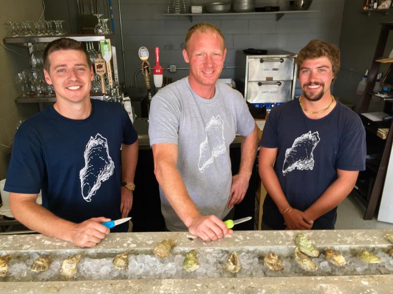 Brendon Parsons, left, Joel Spinney and Noah Begin at River Bottom Raw Bar in Newcastle. SUZI THAYER/Boothbay Register