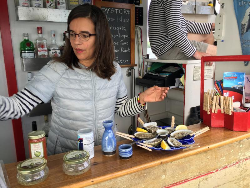 Olga Oros shucks and serves samples of the different brands of oysters from the Damariscotta River. SUZI THAYER/Boothbay Register