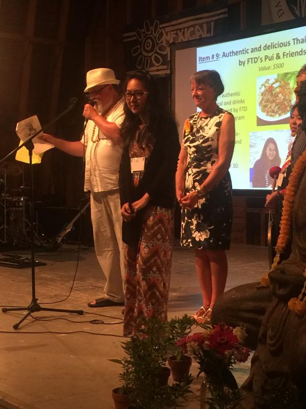 Gimbel auctions off an authentic meal made by Pui, center, and friends. JOSEPH CHARPENTIER/Boothbay Register