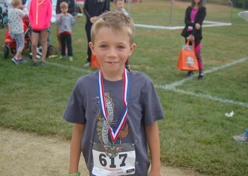 Ben Lewis receives his race medal. ART MAYERS/Boothbay Register