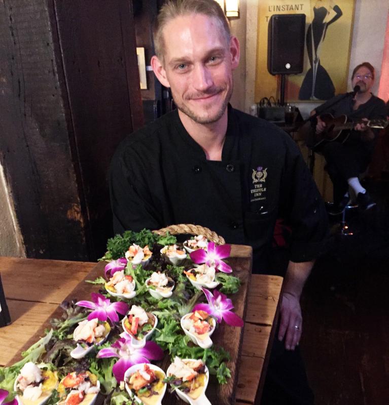 Owner-chef Dick Reid shows off his winning tasty bite: butter-poached lobster with truffled (Thistle) newburg sauce, on a pan seared saffron risotto cake, with microgreens, and a port wine reduction, at The Thistle Inn. SUZI THAYER/Boothbay Register