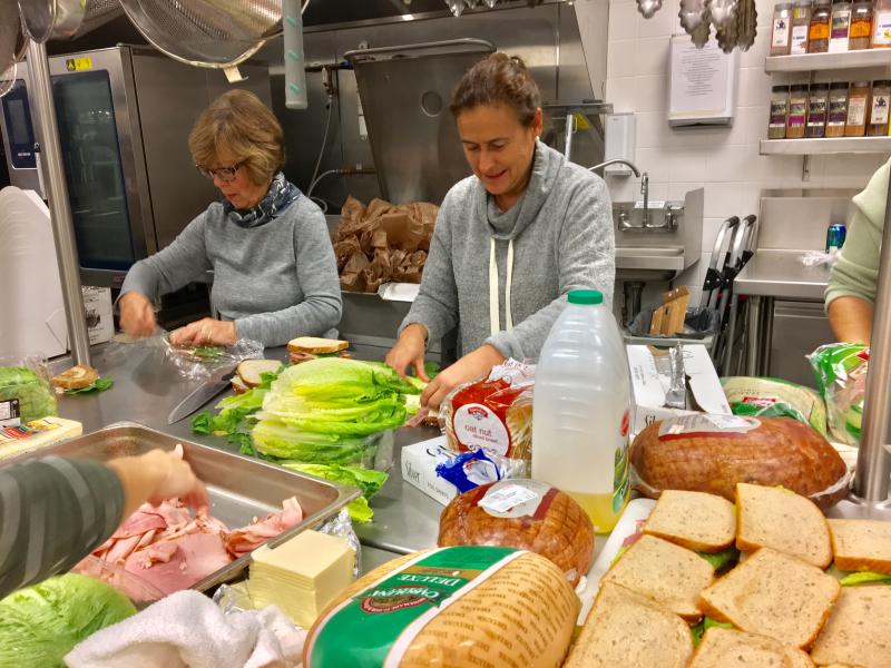 Laura Honey, left, and Rachel Leeman help on the assembly line putting lunches together in the kitchen of the Boohbay Harbor Country Club. SUZI THAYER/Boothbay Register