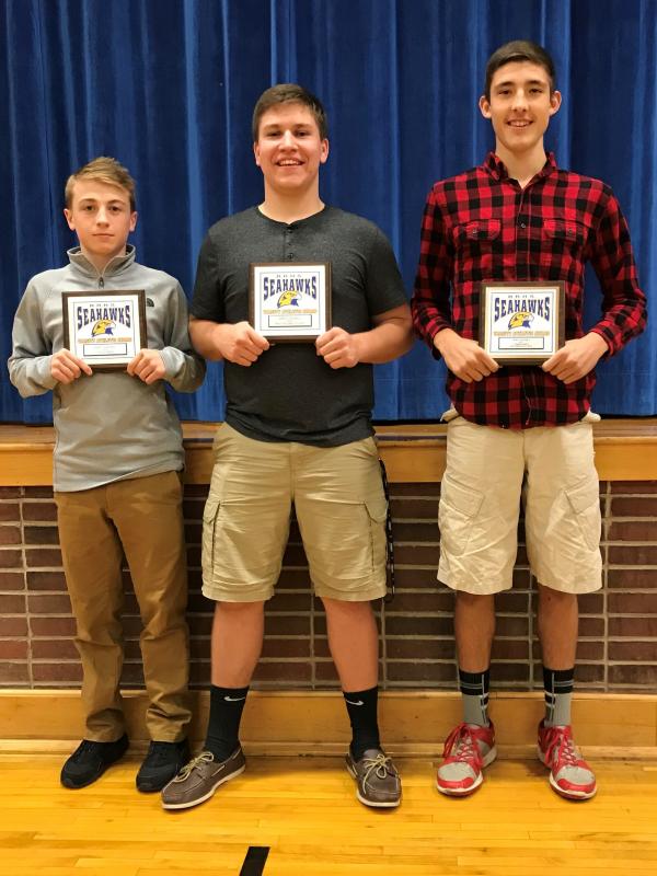 Football plaque winners, from left, Stephen Bennett, Coaches Award; Cameron Crocker, MVP; and Jay Hasch, MIP. Courtesy of Candie Crocker