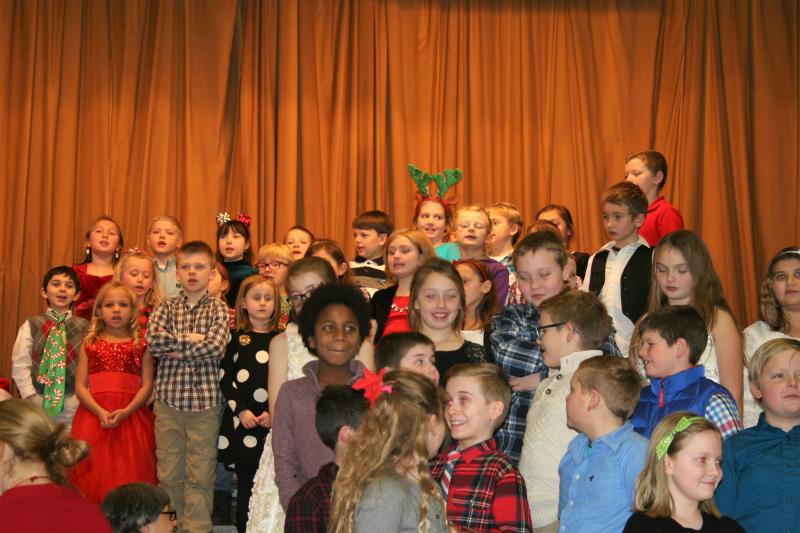 Expressive second and fourth grade students sing “When Christmas Comes To Town.” LISA KRISTOFF/Boothbay Register Expressive second and fourth grade students