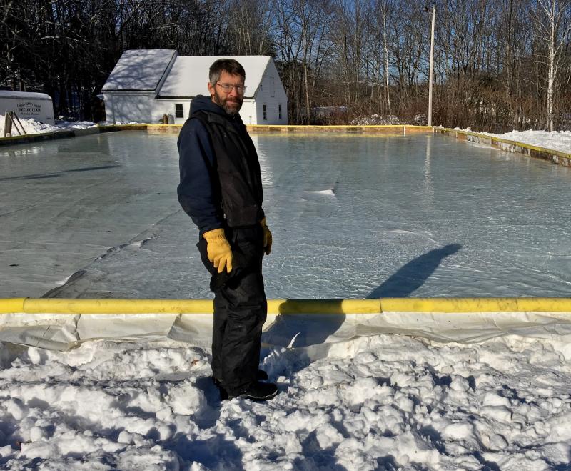 Kevin Anthony keeps a close eye on the water being pumped into the rink from the fire station on Dec. 28. SUZI THAYER/Boothbay Register