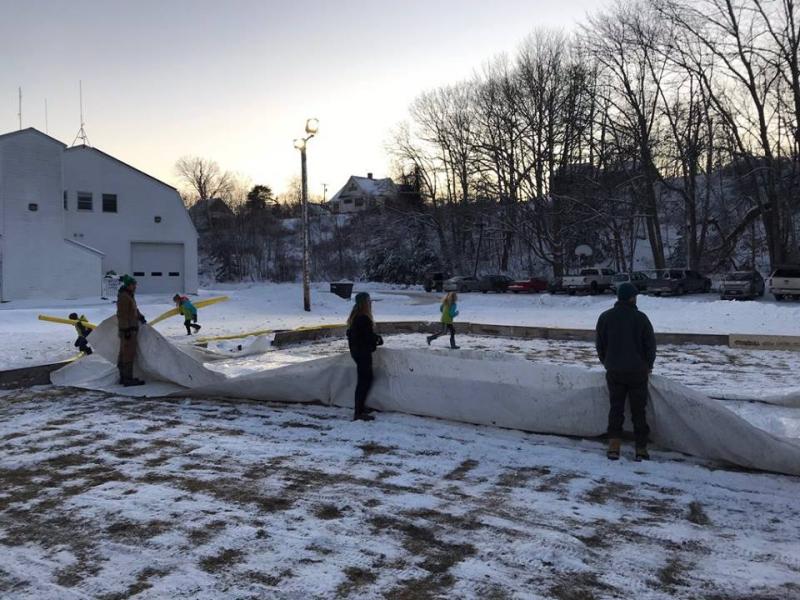Volunteers set the liner in the rink on Dec. 27. Courtesy of Mame Anthony