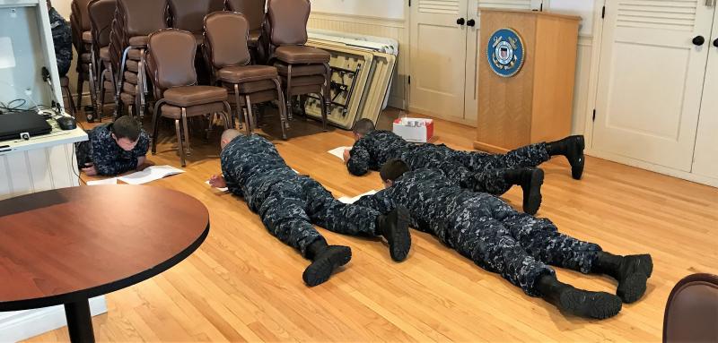 “Drop and give me 50!” Far from lying down on the job, four members of the Naval Sea Cadet Corps work their way through the 50-question final exam for the “About Boating Safely” class which was held at USCG Sector Northern New England Sat/Sun. Nov. 11/12. Five members from USCG Auxiliary Flotilla 25 in Boothbay Harbor served as instructors and proctors for the 35 cadet class. Courtesy of Ted Chatham/USCG Auxiliary