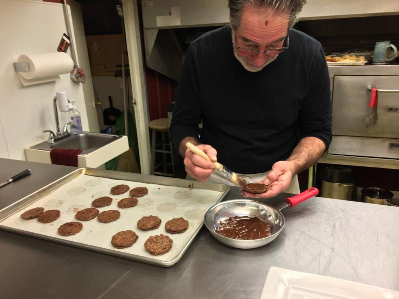 Bernie DeLisle whips up some double-chocolate pecan cookies at Osteria Bucci. SUZI THAYER/Boothbay Register