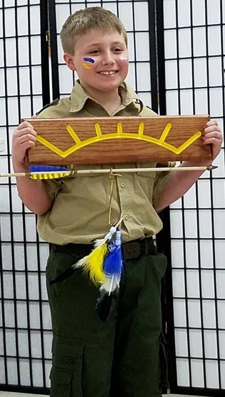 New Boy Scout Grahm Cox of Boothbay, with his Arrow of Light plaque and bead and feather adorned arrow. Courtesy of Robin Ford