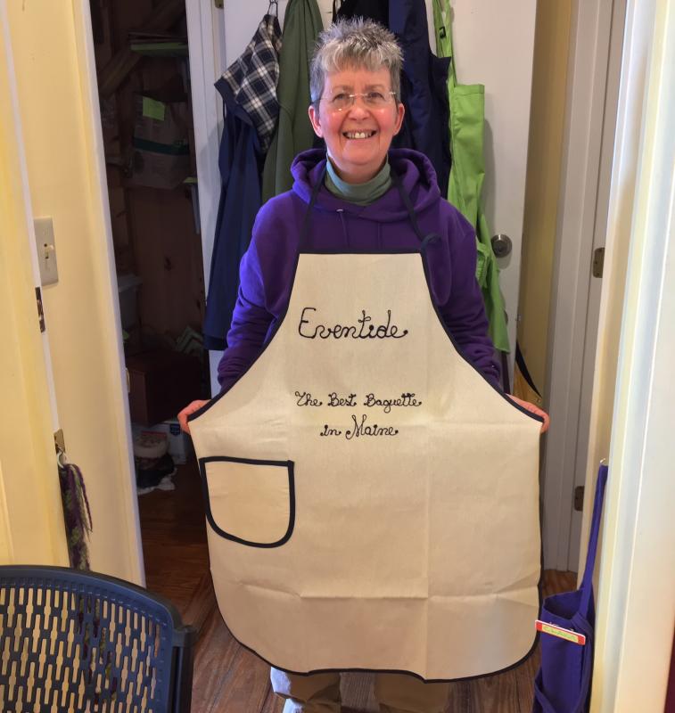 Kim Martin shows off an apron from a friend/client from Genoa, Italy, who had it made for her, in Genoa, saying Martin made the best baguette in the U.S. SUZI THAYER/Boothbay Register
