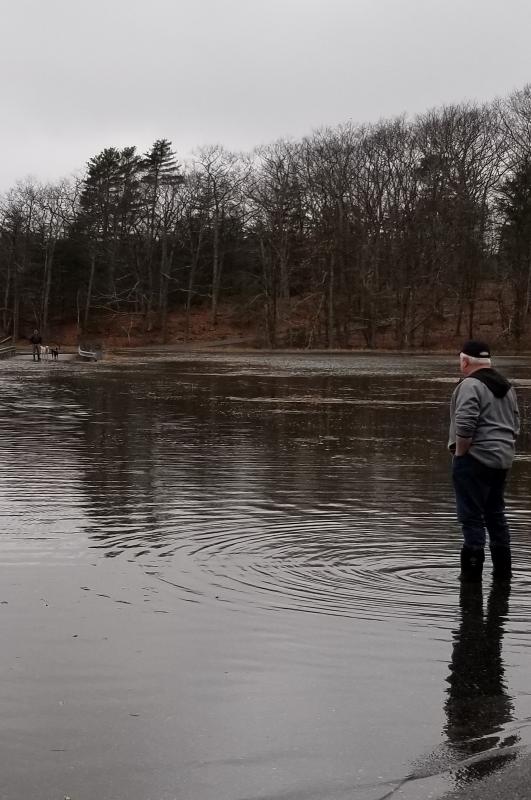 Bob Gravino stands on a flooded road in Georgetown this March. The May 2 lecture focuses on ways that local communities can be prepared to deal with issues like coastal flooding and extreme storms. Kathy Gravino photo