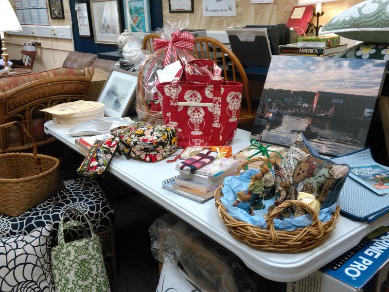 Services and items for the Boothbay Harbor Rotary Club’s annual Kentucky Derby party on May 5 arrive and are readied for the event’s silent auction. JANE CARPENTER/Boothbay Register