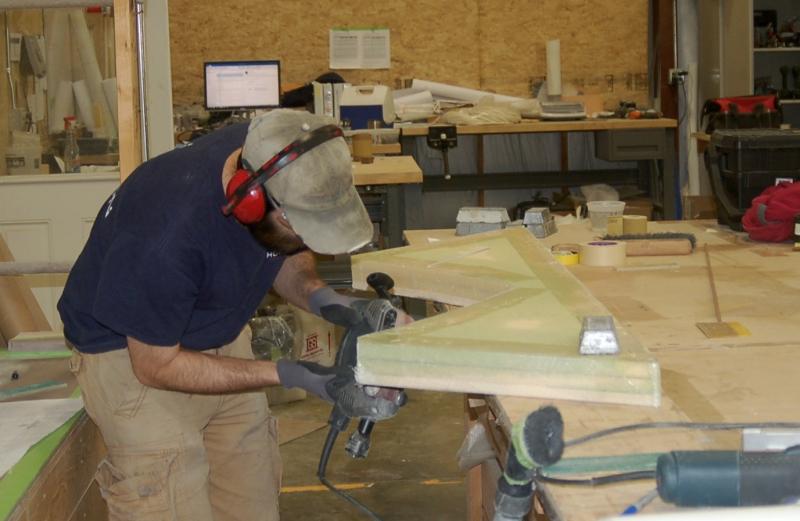 Andrew Follett polishes a tender support. ART MAYERS/Boothbay Register