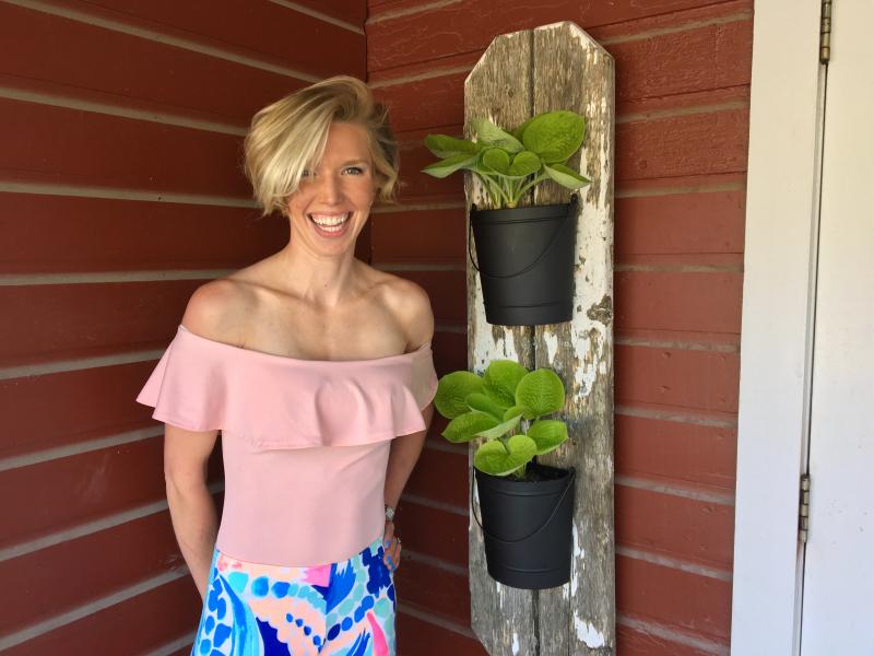 Bailey Bartlett at Montsweag Farms Restaurant, next to one of her pieces of plant art. SUZI THAYER/Boothbay Register