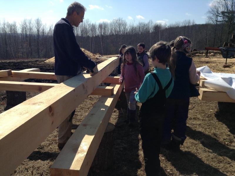 Kinne Stires discusses timber frame joinery with Juniper Hill kindergarten students. Courtesy of Anne Stires/Juniper Hill School
