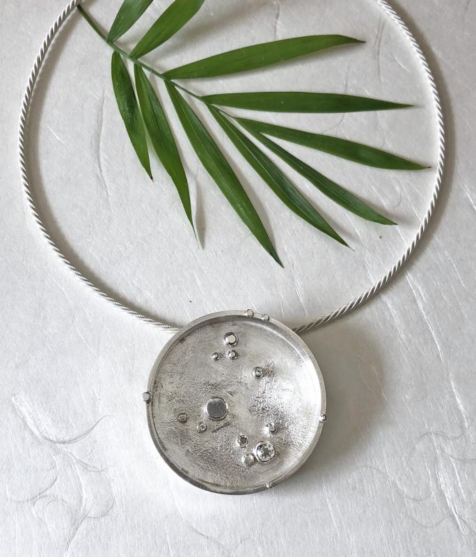 Christine Peters’ reticulated circle pendant/pin/necklace with aquamarine. Courtesy of Christine Peters Christine Peters