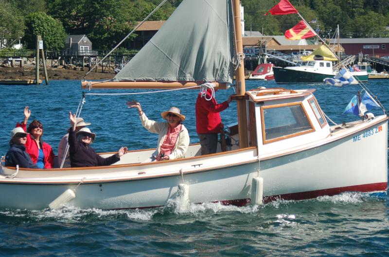 Antique boat sailors wave to the crowd. ART MAYERS/Boothbay Register