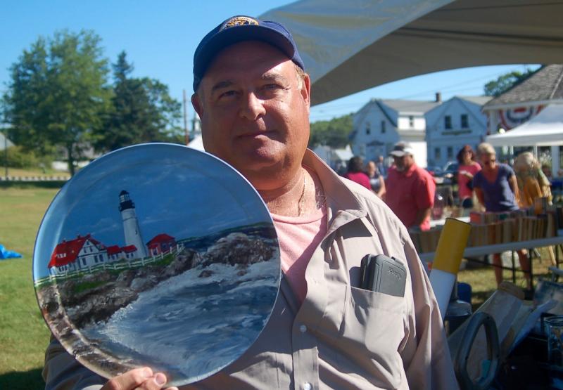 Calculus teacher Will Desalazar of Deerfield Beach, Florida picks up a Maine memento for his classroom. ART MAYERS/Boothbay Register