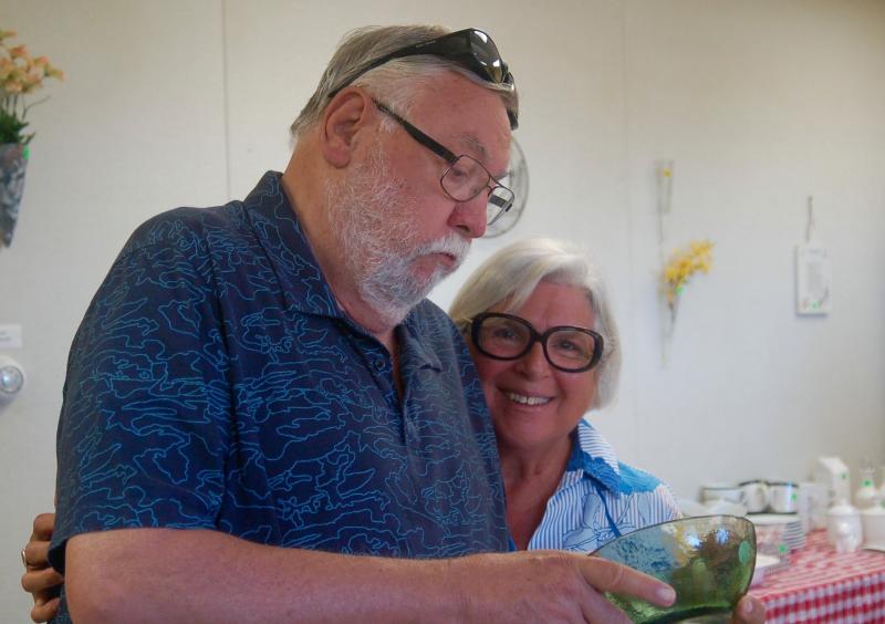 Dave and Christine Williams of Lawrence, Kansas check out a glass serving dish. ART MAYERS/Boothbay Register