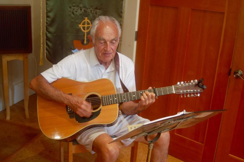 The Rev. John Ineson plays the guitar. ART MAYERS/Boothbay Register