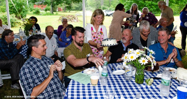 Volunteer Terri Wells delivers a magnificent blueberry lemon layer cake with lemon cream cheese icing to high bidders at Sunday evening’s Kermess fundraiser for Lincoln County Historical Association. Bob Bond photo