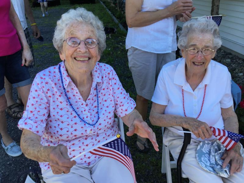 Fourth of July Parade honorees Evelyn Sherman, left, and Jean Thompson, sit in the shade before riding in Jim Singer’s convertible. ISABELLE CURTIS/Boothbay Register