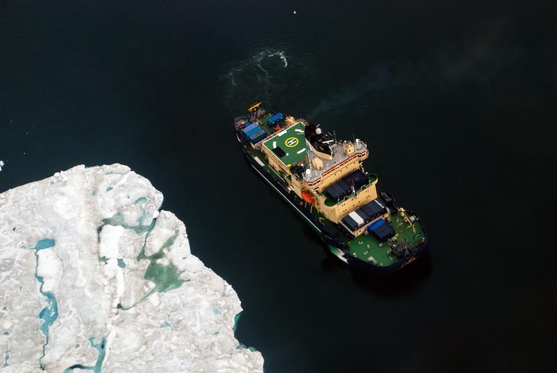 The Swedish icebreaker Oden navigates the coast of Greenland during a research expedition in 2015. Oden will spend a month moored to an ice floe in the Arctic Ocean this summer, enabling Bigelow Laboratory researcher Paty Matrai to study how the ocean influences cloud formation. Courtesy of Ida Kinner