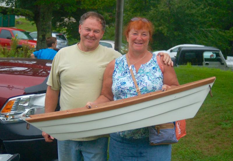 Berchel and Lisa Rollins buy their dream boat at the Southport Fire Department auction. ART MAYERS/Boothbay Register
