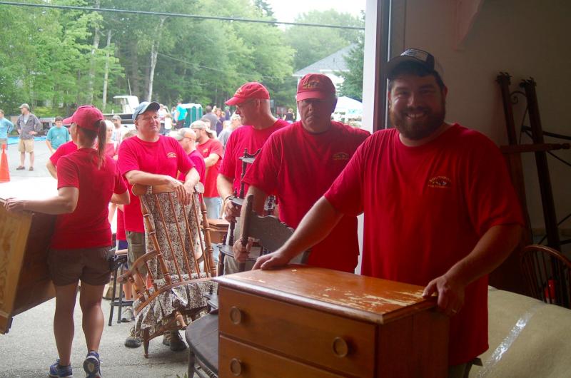 Volunteers line up auction items. ART MAYERS/Boothbay Register