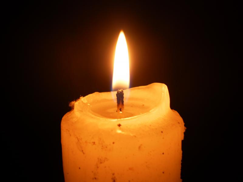 Lit candle with melted wax - Stock Image - C036/0272 - Science Photo Library