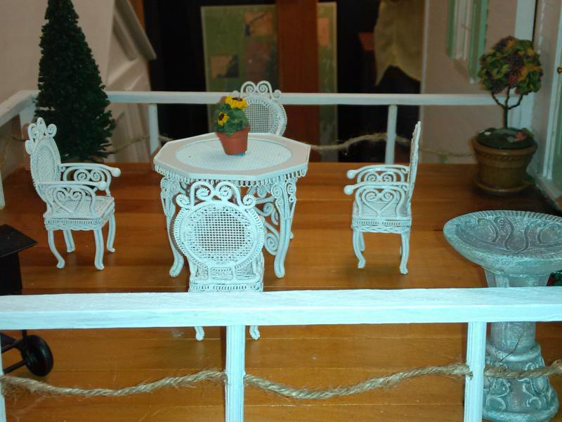 The rooftop terrace includes a birdbath, Victorian furniture and a topiary. JANE CARPENTER/Boothbay Register