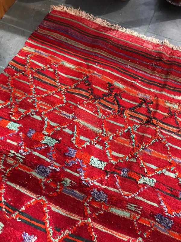 A rare red Talsint area rug at Gleason Fine Art. Courtesy of Kathleen Jones