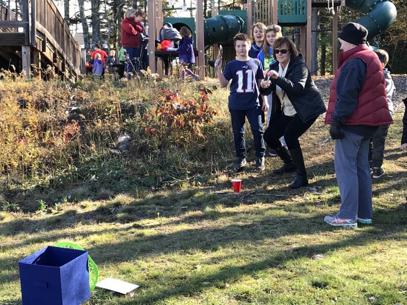 Principal Lisa Clarke takes aim. KELLIE BIGOS/Boothbay Register