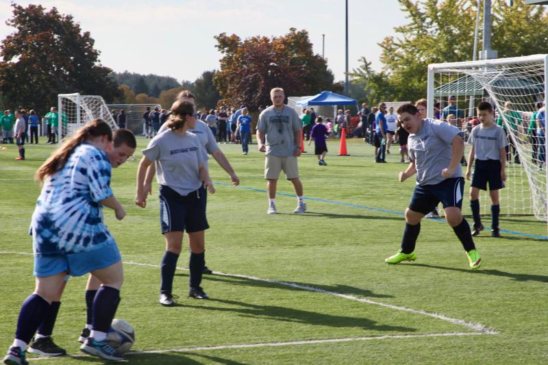 Valerie and Vincent Giles playing with Zander Blake in the goal. Earl Brewer photo