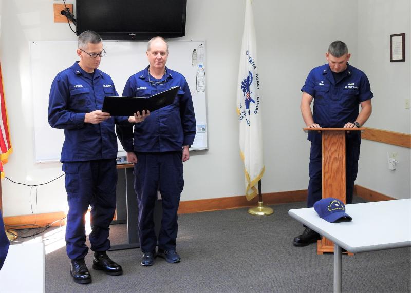 Capt. Brian J. LeFebvre, left, commander, USCG Sector Northern New England, presents the “Coast Guard Auxiliary Commendation Medal” to Coast Guard Auxiliary member Bruce MacCormac (center) at a ceremony held Oct. 5 at USCG. Station Boothbay Harbor. At right is CG Station Boothbay Harbor Officer in Charge, Chief Adam Smart. Coast Guard Auxiliary members routinely serve alongside the active duty Coast Guard and, with training identical to the active duty, may perform virtually any tasks open to the active duty apart from law enforcement or combat. Coast Guard Auxiliary photo by Ted Chatham